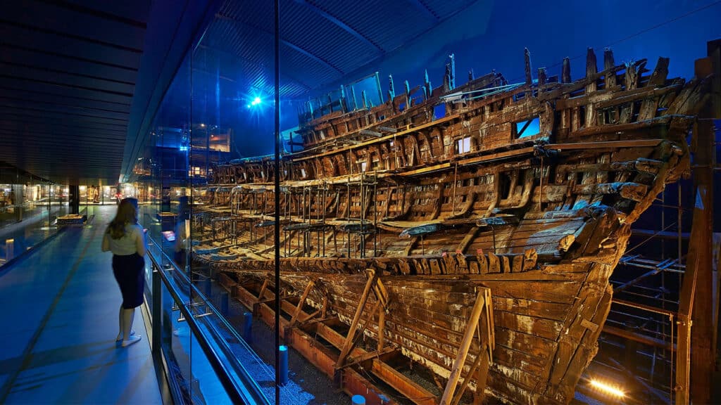 A woman looks at the Mary Rose from the Lower Decks gallery